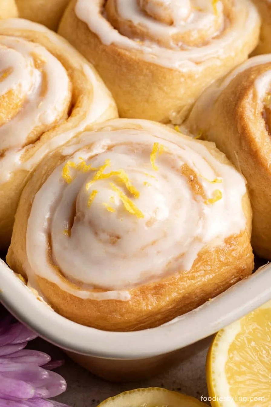 Zesty Lemon Rolls swirled with lemon filling and topped with glaze